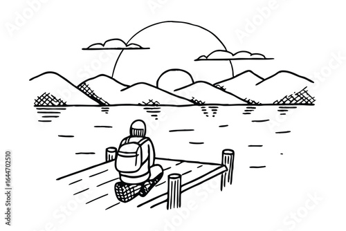 Person with backpack sitting on a dock overlooking mountains and lake