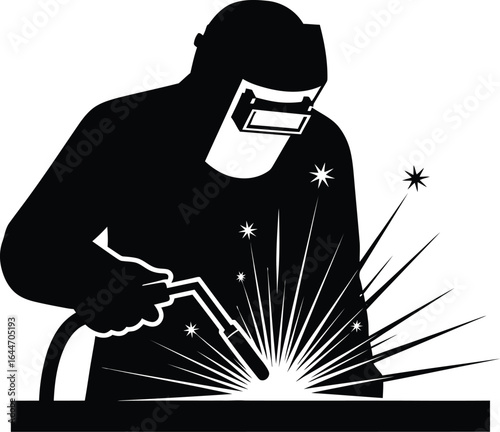 Welder at work with welding machine and helmet