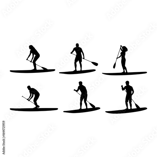 Stand up paddleboarders in silhouette stand up paddleboarding