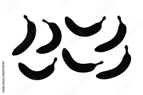 Six black banana silhouettes scattered on a white background fruit food