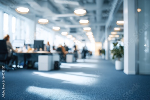 Wallpaper Mural Blurred view of a modern office space with numerous workers at desks.  Sunlight streams in, illuminating the carpeted floor.  Ceiling-mounted lights are visible Torontodigital.ca