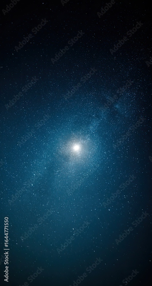 Fototapeta premium A luminous orb dominates a deep teal night sky, speckled with countless distant stars and a hazy galactic swirl