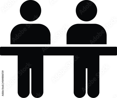 Two silhouetted figures sitting at a long table or counter