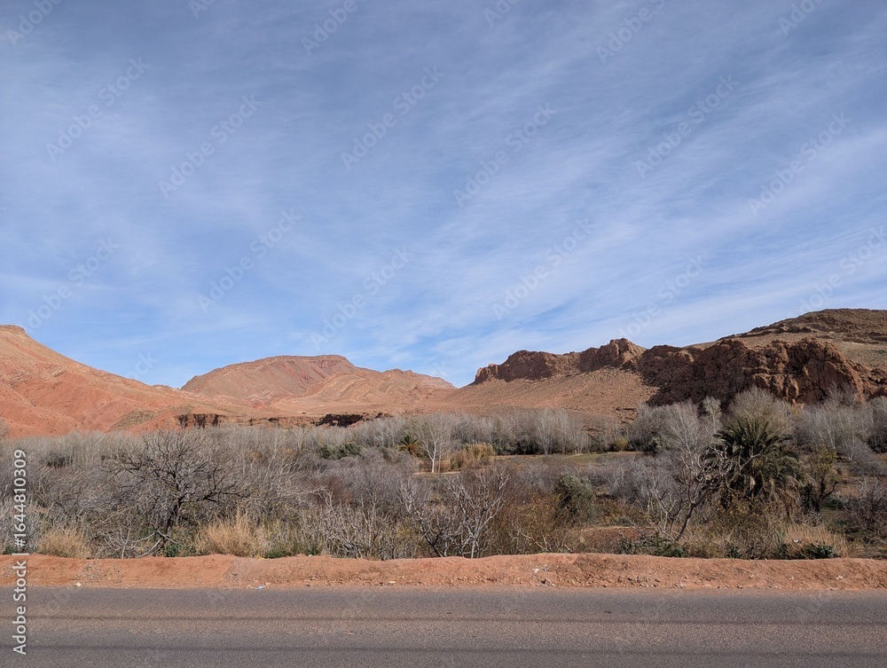 Fototapeta premium Desert landscape with red rocky mountains and a clear blue sky in a remote area in Morocco