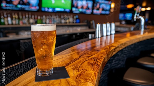 Golden Beer on a Modern Wood Bar Top in a Sports Bar