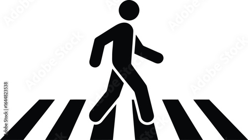 Silhouette of a person walking across a black and white striped pedestrian crossing