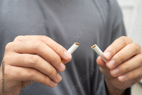 Bild auf Leinwand Quit smoking, Asian teenage man breaking destroy cigarette in hand