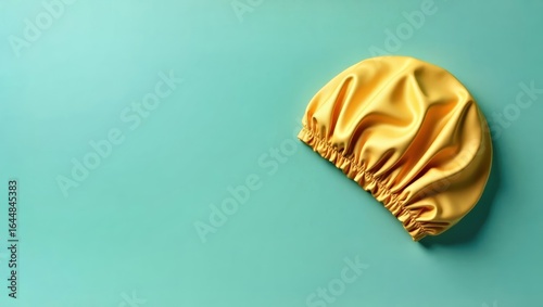 Sleep Bonnet. Yellow shower cap on turquoise background, hygiene, bath