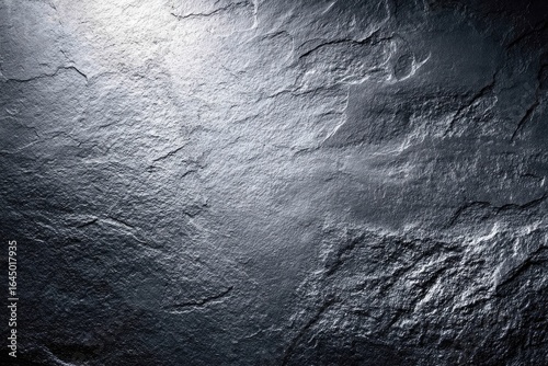 Dark gray stone surface with light highlights
