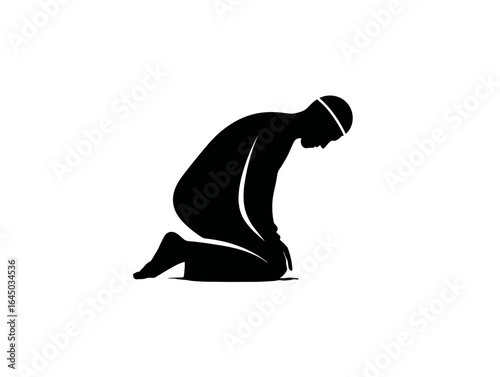 Muslim man praying in a kneeling position with a solemn expression  