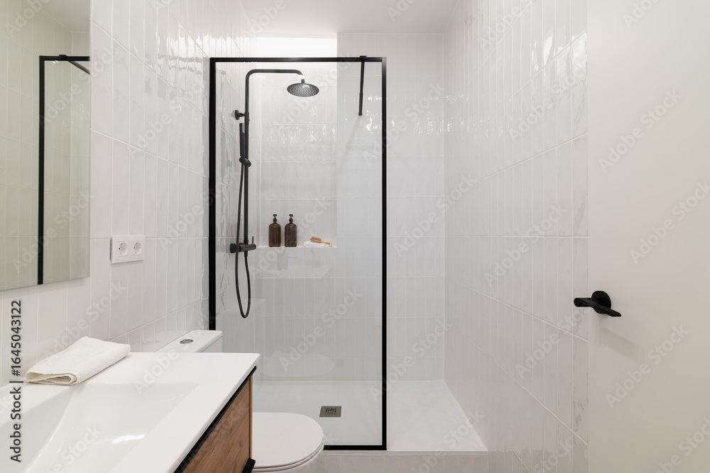 custom made wallpaper toronto digitalModern bathroom with a glass shower enclosure, white tiles, and a wooden vanity. Minimalist design with toiletries on the shelf and a clean aesthetic.