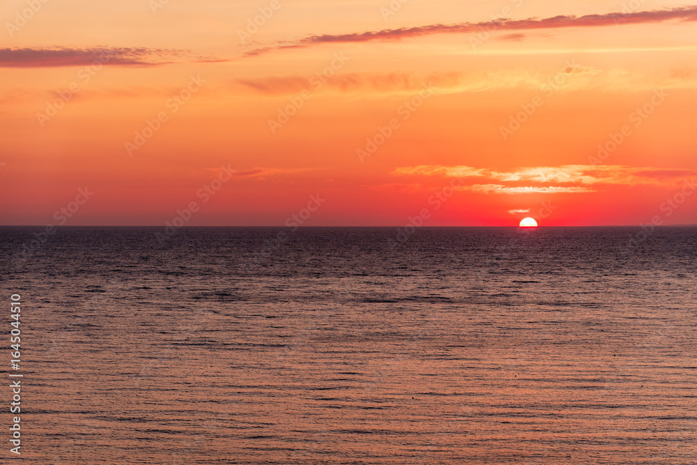 Fototapeta premium Beautiful red and orange sunrise over the sea.