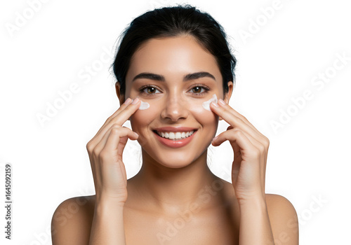 Smiling woman applying eye cream with fingers