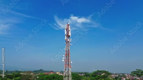 Telecommunication tower with antennas and satellite dishes for mobile network and wireless communication infrastructure against clear sky background. Telecommunication cellular 4G and 5G mobile.