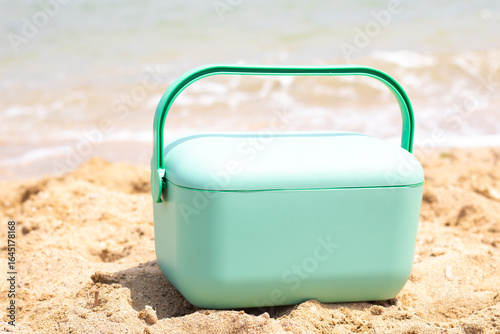 Mint green cooler on the beach