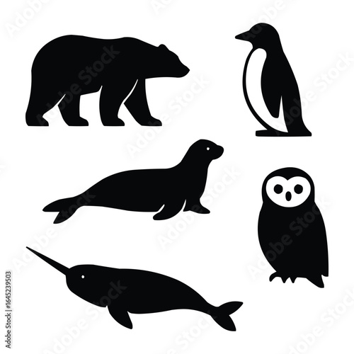 Collection of arctic and antarctic animal silhouettes including a polar bear penguin seal narwhal and owl isolated on white background silhouette