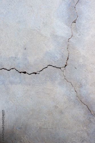 Close-up of cracked and rough concrete for overlay background.