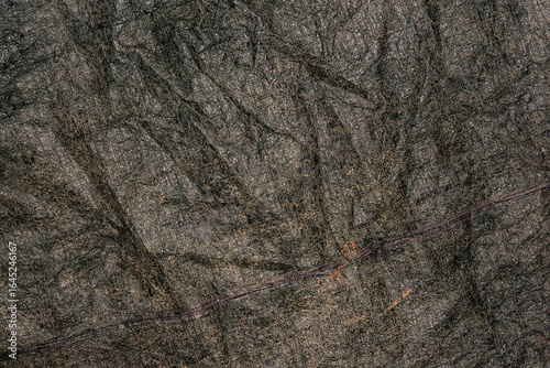 Old black plastic canvas with a rough surface