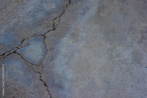 Close-up of cracked and rough concrete for overlay background.