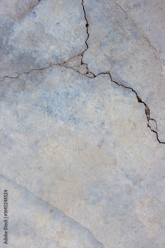 Close-up of cracked and rough concrete for overlay background.