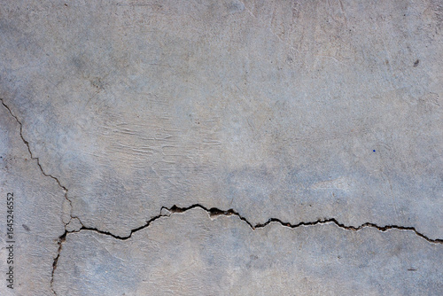 Close-up of cracked and rough concrete for overlay background.