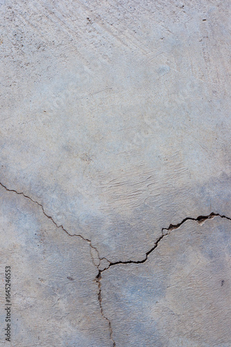 Close-up of cracked and rough concrete for overlay background.