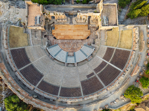 Aerial view of the ancient Teatro Greco, its stone seating contrasting with the bright stage, a relic of history viewed from above, Taormina, Sicilia, Italy.