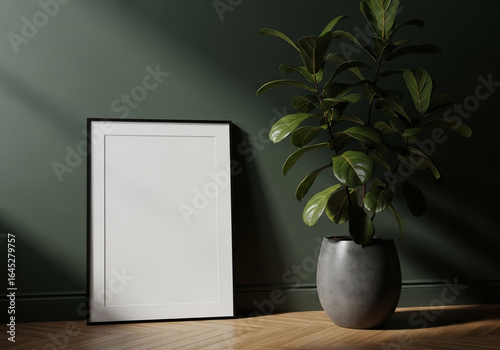 Blank Vertical Frame & Green Plant on Wood Floor by Dark Wall