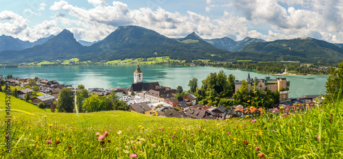 Sankt Wolfgang on Lake Wolfgangsee, panoramic view from a meadow of the landscape with the town, lake, and mountains, Austria