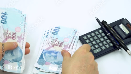 Turkish money 100 TL, female hand when calculating