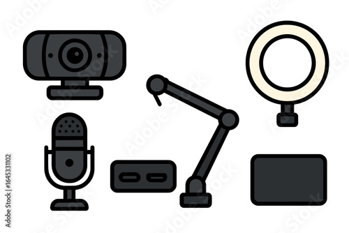 Equipment for content creation including a webcam, microphone, and ring light arranged on a desk setup for streaming or recording