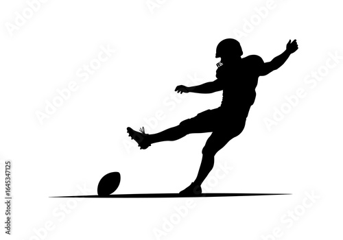 Silhouette of Football Player Kicking Ball