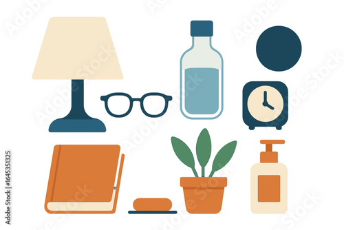 Decorative arrangement of everyday items on a minimalist surface featuring a lamp, books, and a plant in soft colors