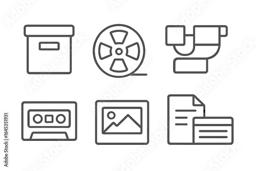 Exploring vintage media storage and formats with boxes, reels, cassettes, and documents in a minimalist design