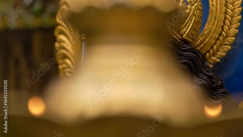 A beautiful and serene portrait of the hindu goddess lakshmi or durga with traditional makeup a golden crown and elaborate jewelry a symbol of divine feminine power


