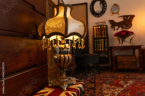 old fashioned lamp in the room, warm indoor yellow light, bookshelf and mirror with wooden frame