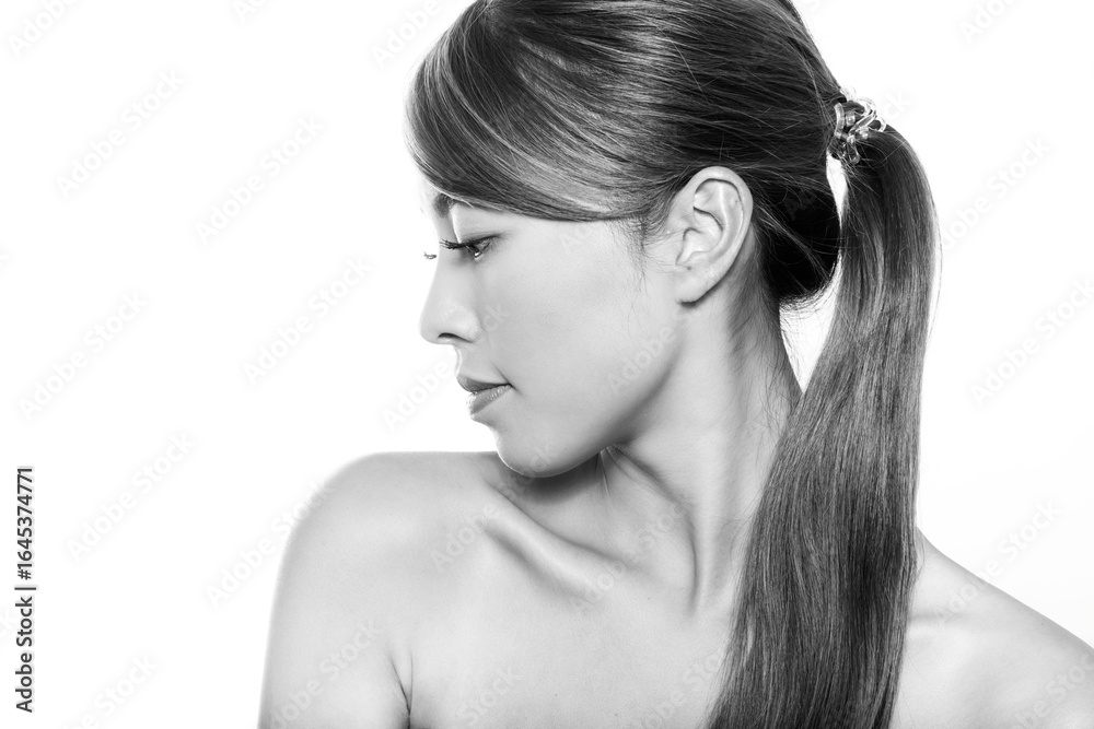 Naklejka premium Beautiful asian woman with long dark and healthy hair and clear skin