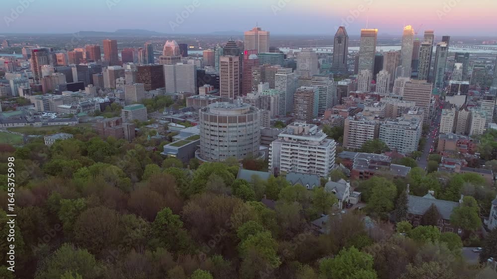 Montreal, Canada: Tourists gather at the Mount Royal lookout to view the city skyline at dusk. The park offers a scenic overlook of the city. Kondiaronk Belvedere, Montreal, Quebec, Canada. Montreal, Canada: Tourists gather at the Mount Royal lookout to view the city skyline at dusk. The park offers a scenic overlook of the city. Kondiaronk Belvedere, Montreal, Quebec, Canada.