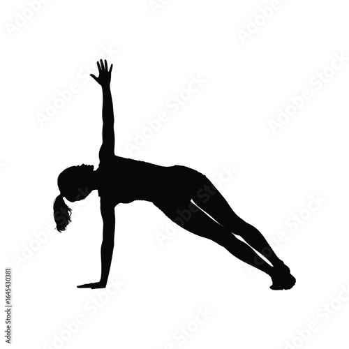 Silhouette of a woman performing a side plank yoga pose