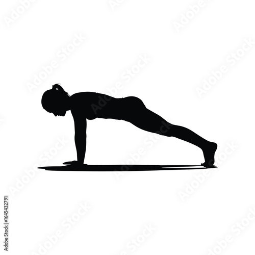 Silhouette of a woman performing a plank exercise on a yoga mat