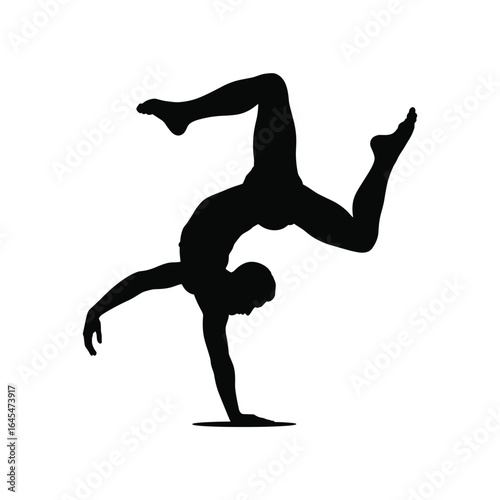 Silhouette of a male dancer performing a dynamic handstand with legs extended