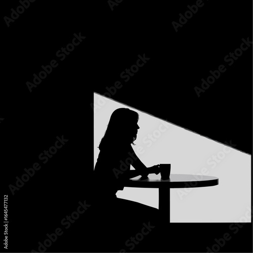 Woman sitting at a table holding a cup in a dimly lit room  