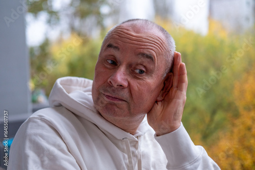 Murais de parede man covering ears with pained expression, Emotional portrait showing discomfort