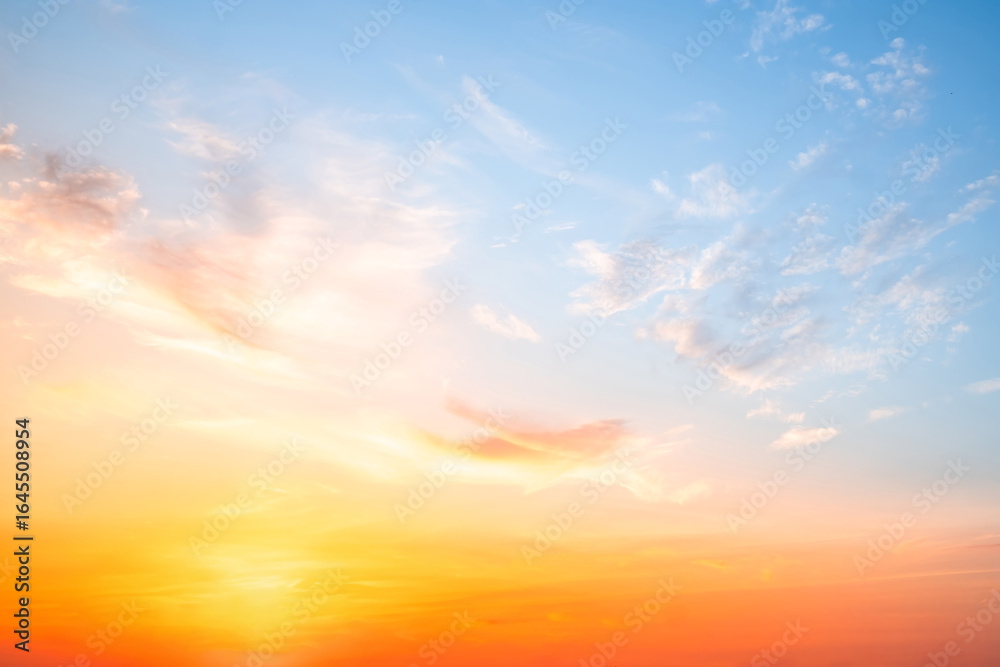 Obraz premium Beautiful , luxury soft gradient orange gold clouds and sunlight on the blue sky perfect for the background, take in evening,Twilight, Large size, high definition landscape photo