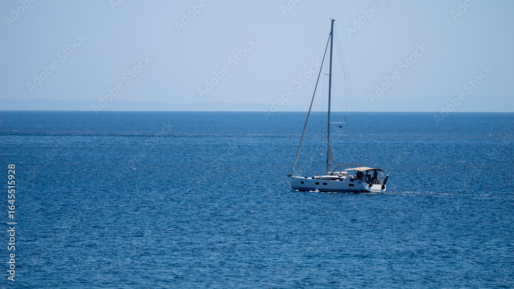 Sailing Yacht Cruising Peacefully Across the Deep Blue Sea Sailing Yacht Cruising Peacefully Across the Deep Blue Sea