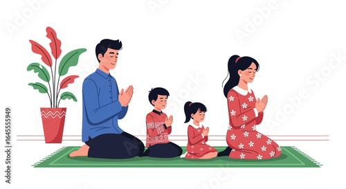 A family of four, including parents and two children, kneeling on a green prayer mat with hands clasped in a respectful or prayerful gesture, depicting a spiritual moment.
