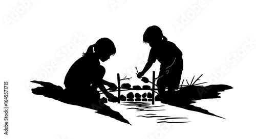 silhouette of two children building a miniature dam fostering creativity and teamwork by a creek