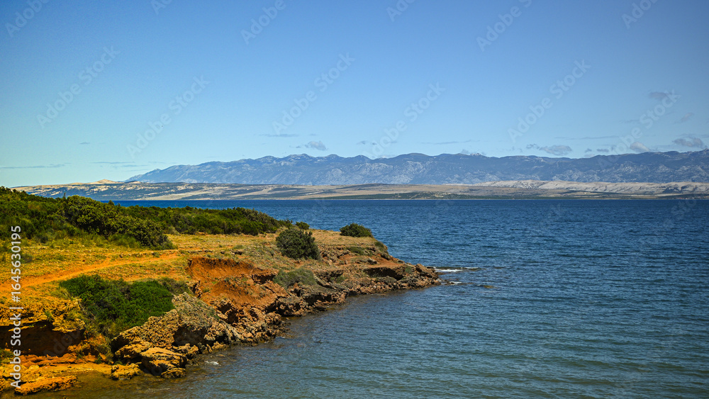 Obraz premium Scenic view of the croatian coastline with the velebit mountain range in the background, showcasing the natural beauty of the adriatic sea