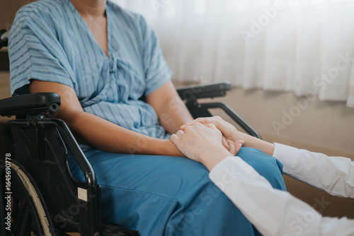 Close up of hand professionals doctor holding to helping and support patient. Female doctor and cancer patient hands to support together. Healthcare for the patient concept.