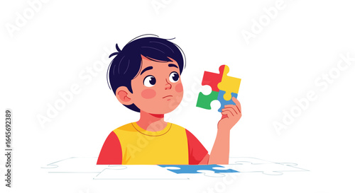Thoughtful young boy holding colorful jigsaw puzzle pieces.